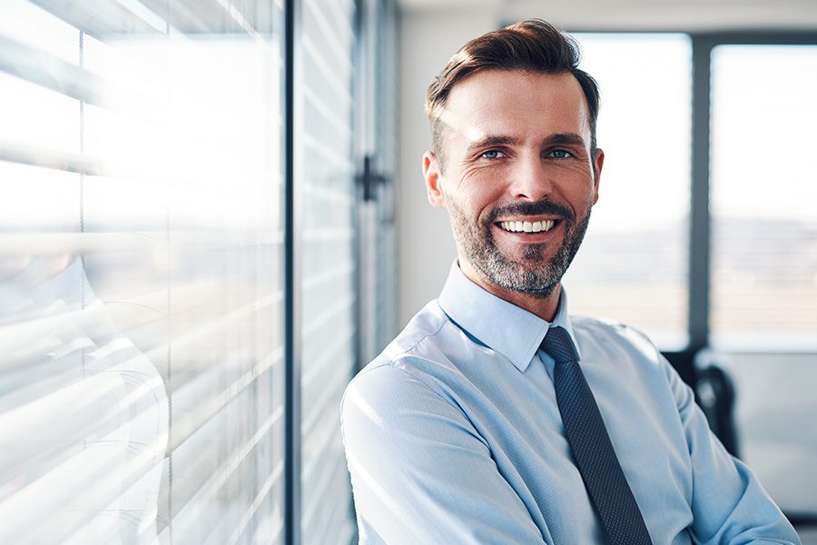 Business Insurance - Portrait of Successful Businessman in Modern Office