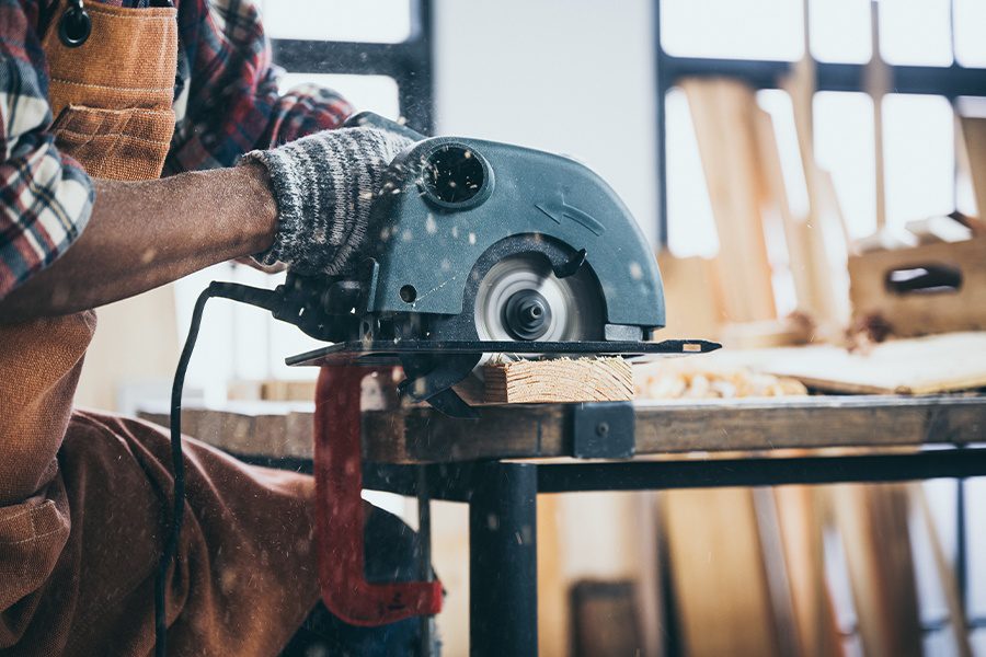 Specialized Business Insurance - The Carpenter is Using an Electric Circular Saw to Cut Wood